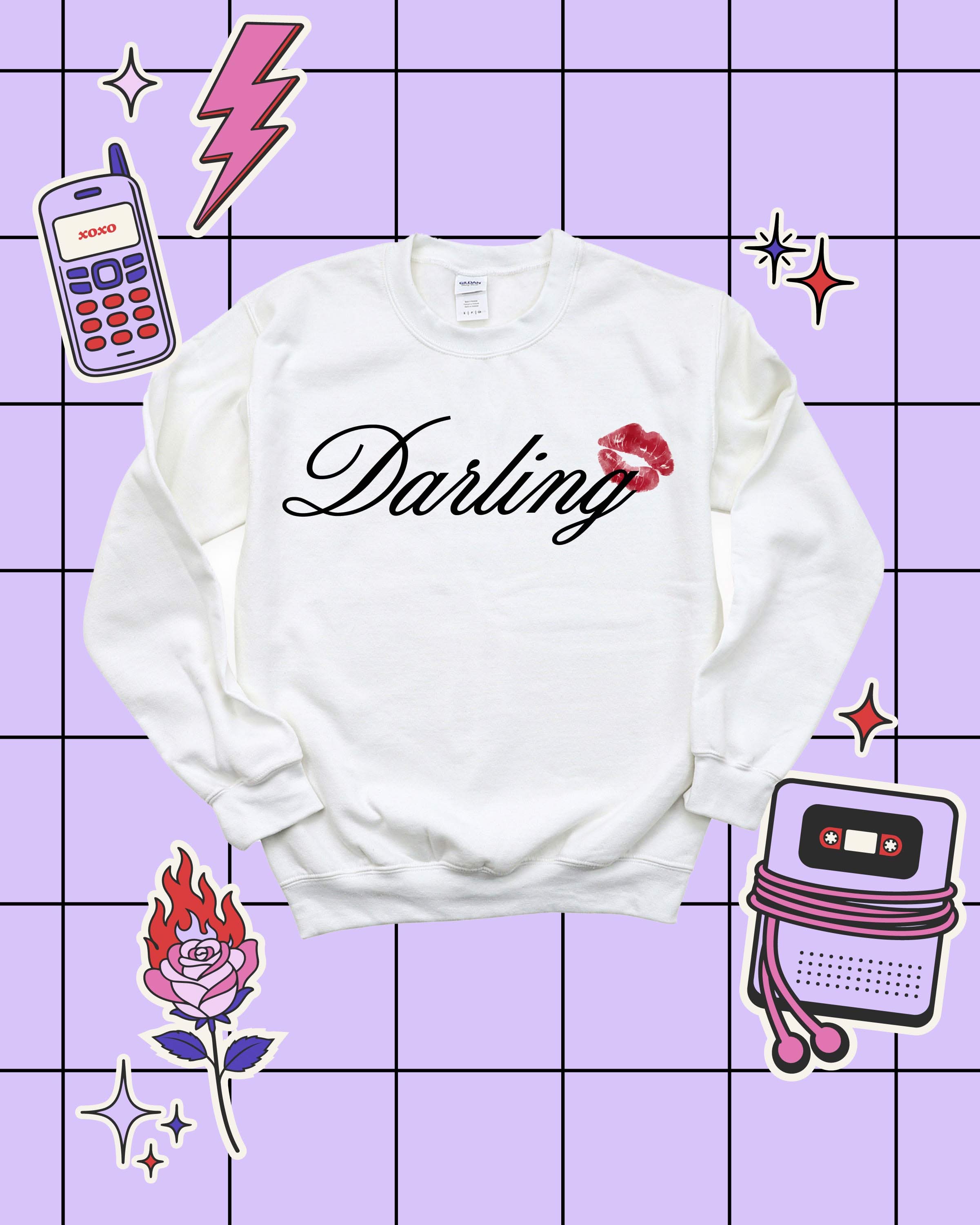 Adult white sweater with "Darling" script and lipstick kiss design, shown on flat lay  – Little Mama Shirt Shop