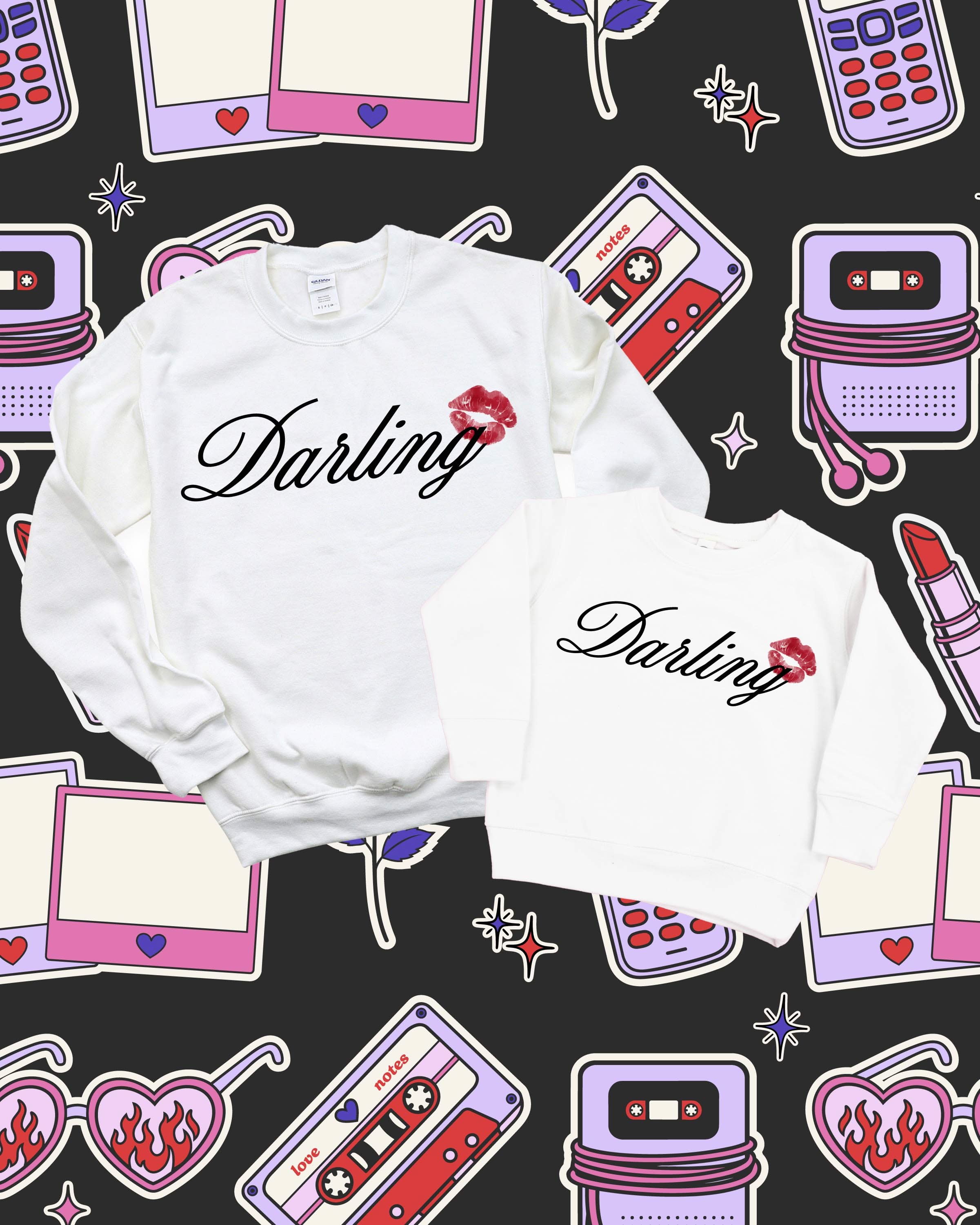 Adult and child white sweaters with "Darling" script and lipstick kiss design, shown on flat lay  – Little Mama Shirt Shop