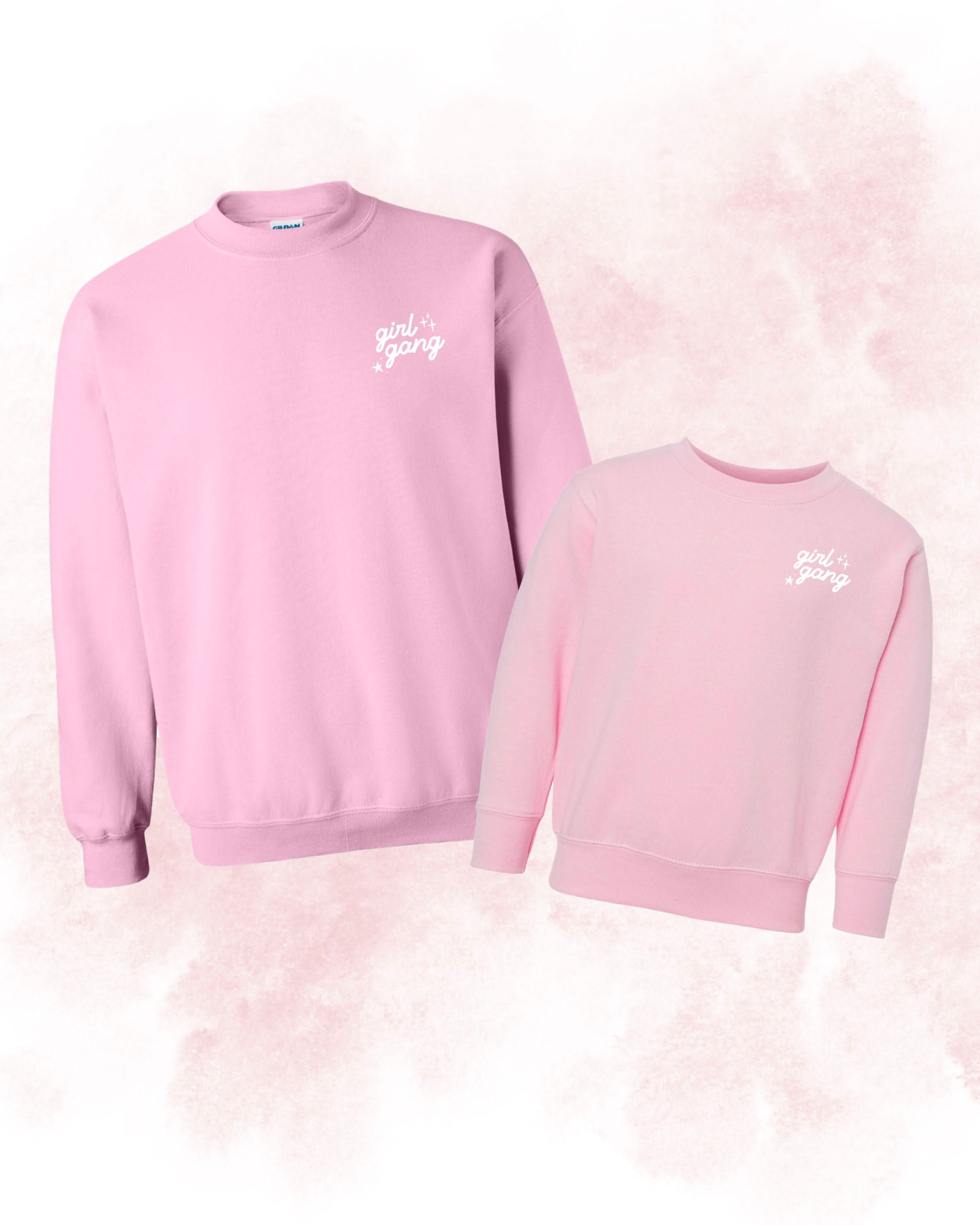 Adult and child sweaters in light pink with "girl gang" design on front chest, shown on flat lay - Little Mama Shirt Shop