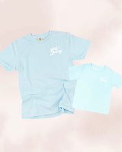 Adult and child tees in chambray and ice blue with "girl gang" design on front chest, shown on flat lay - Little Mama Shirt Shop