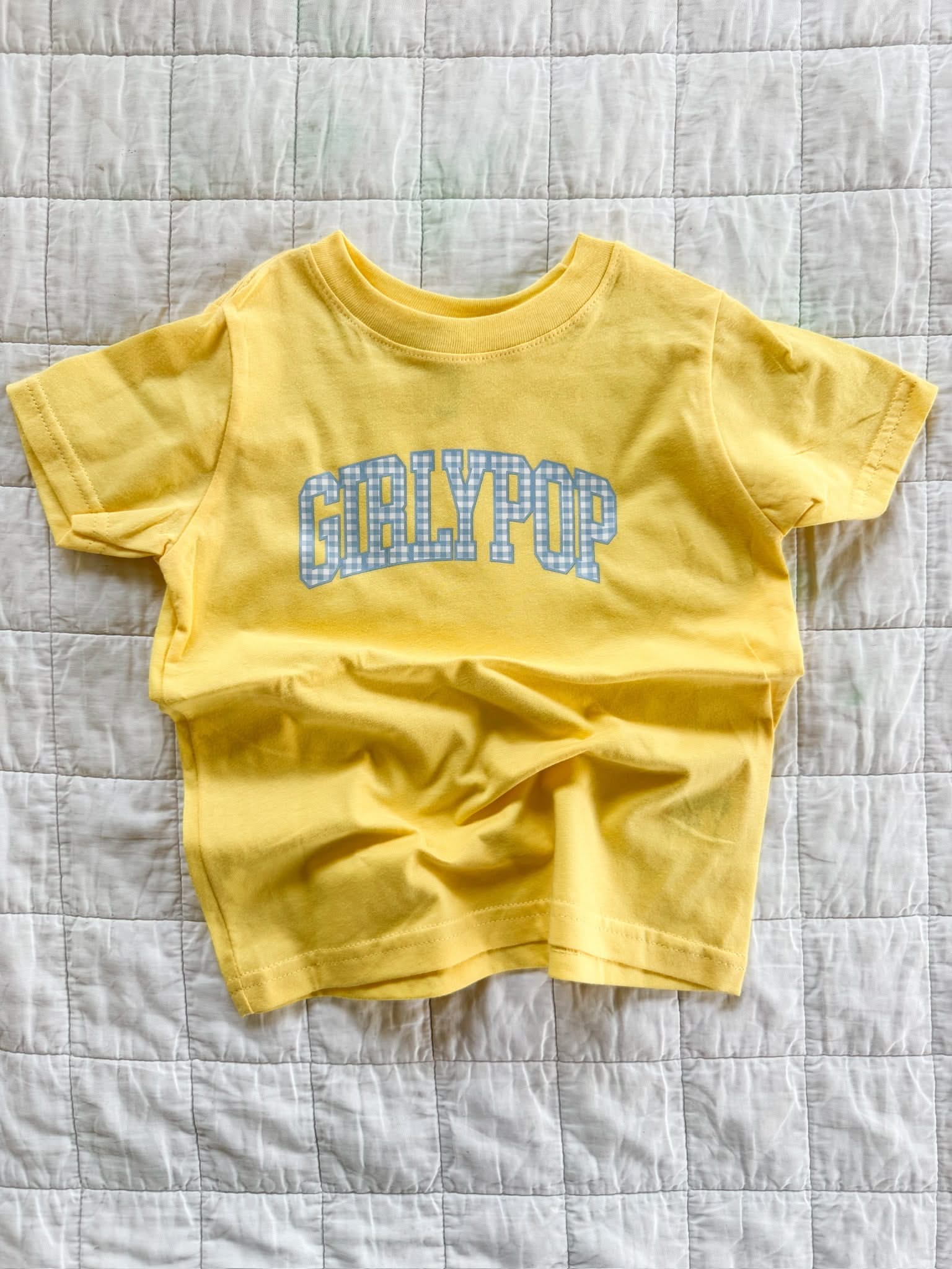 Butter yellow girls t-shirt with blue gingham “girlypop” graphic