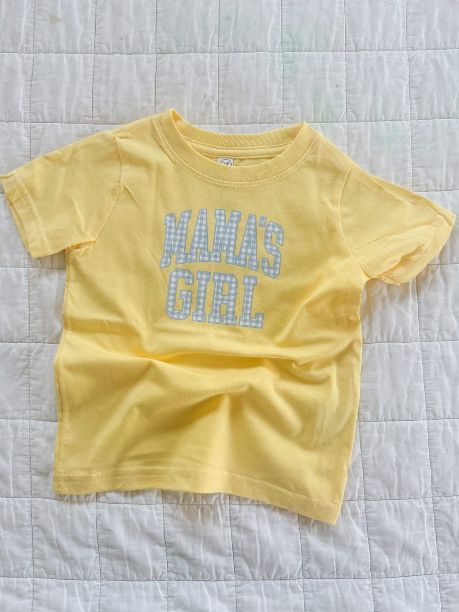 Butter yellow girls t-shirt with blue gingham “mama’s girl” graphic