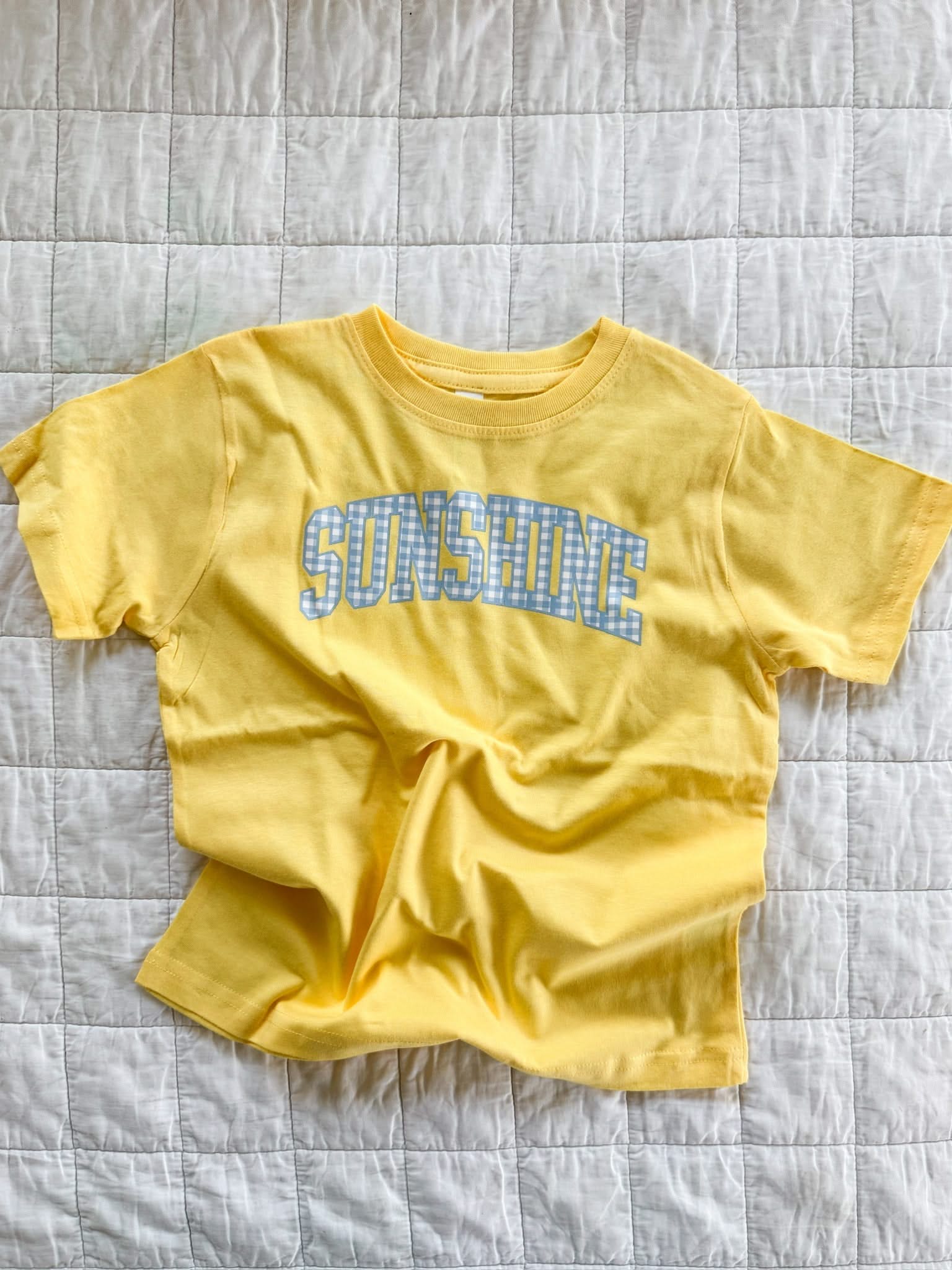 Butter yellow girls t-shirt with blue gingham “sunshine” design