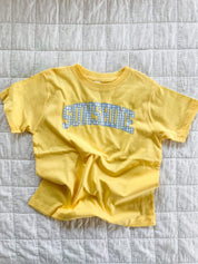 Butter yellow girls t-shirt with blue gingham “sunshine” design