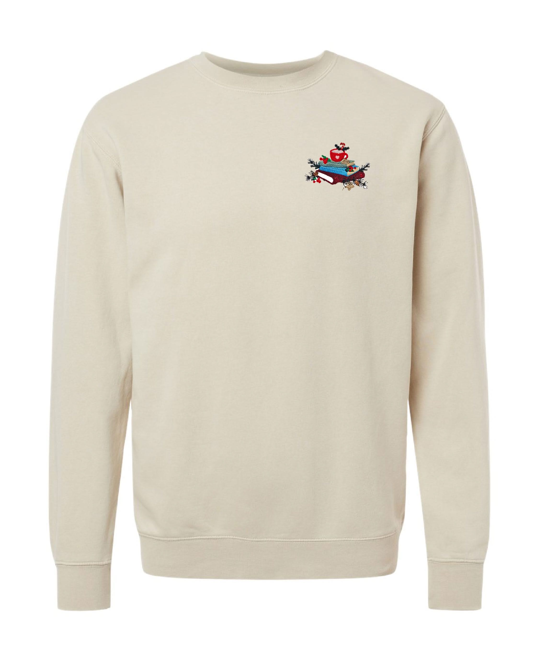 crewneck in ivory with embroidered stack of books on front, shown on flat lay – Little Mama Shirt Shop