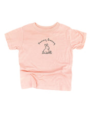 Child tee in blush with 'Hunny Bunny' text and little bunny outline on front, seen on flat lay - Little Mama Shirt Shop