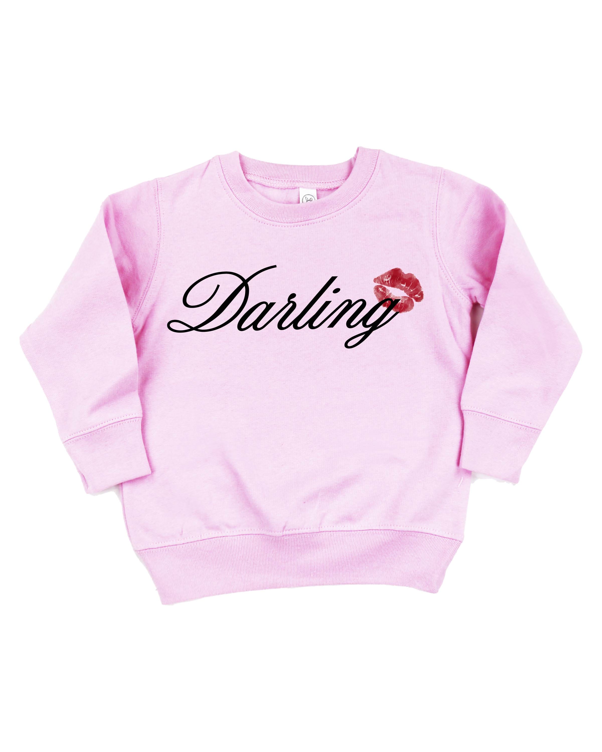 Child pink sweater with "Darling" script and lipstick kiss design, shown on flat lay  – Little Mama Shirt Shop