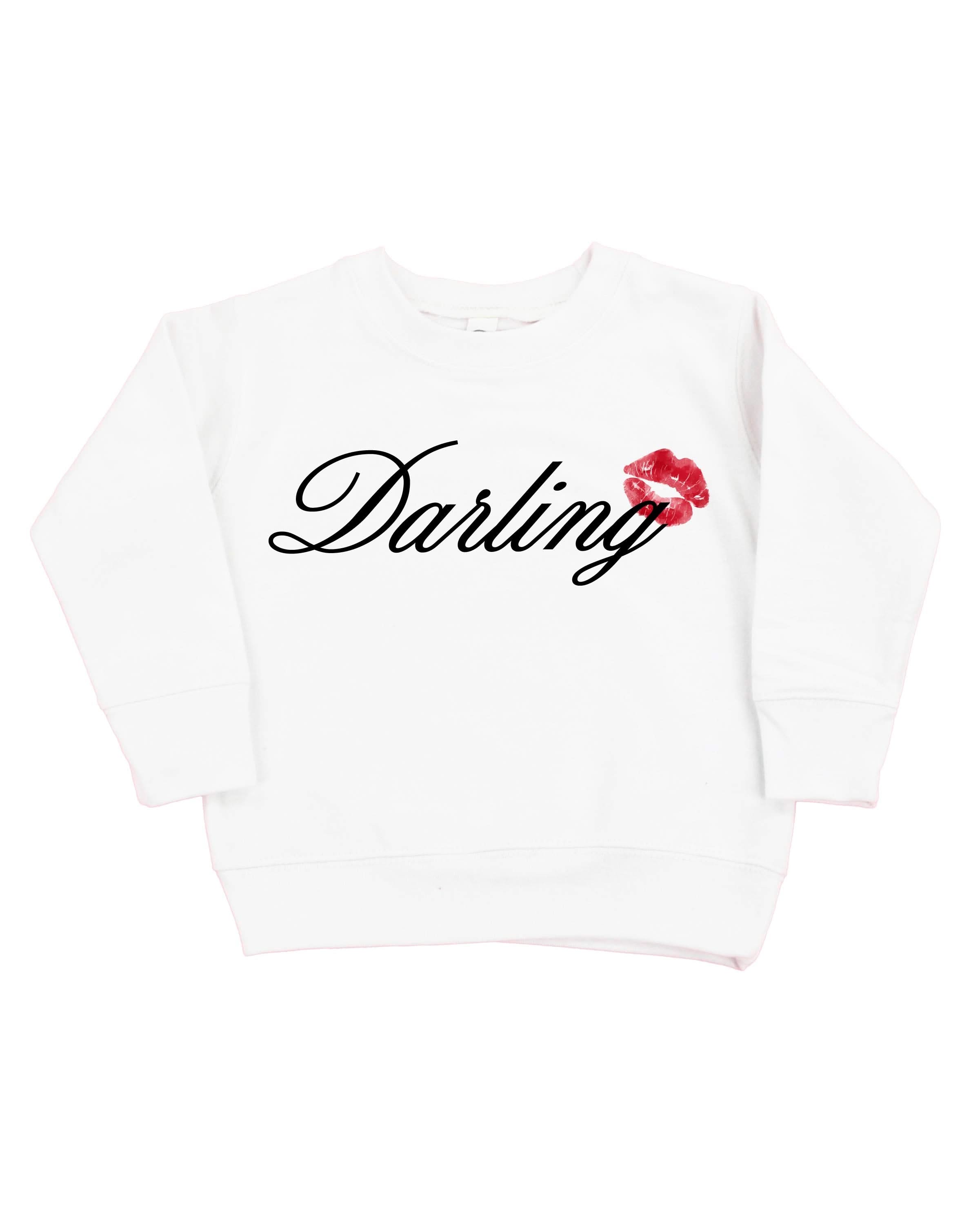 Child white sweater with "Darling" script and lipstick kiss design, shown on flat lay  – Little Mama Shirt Shop