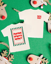 Child natural tee with 'making spirits bright' graphic, shown on flat lay – Little Mama Shirt Shop