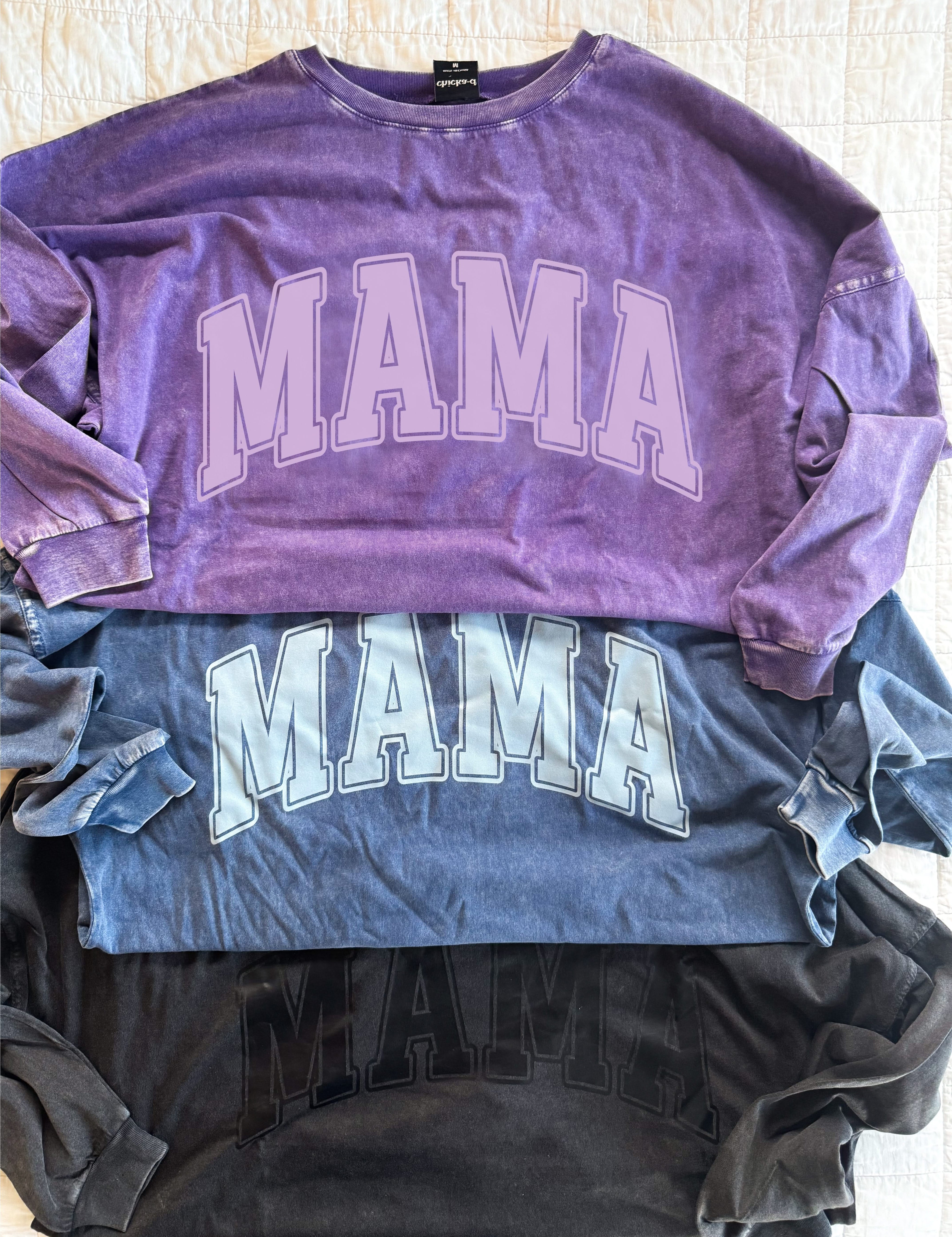 Oversized Big Tee with “MAMA” graphic in purple, washed denim, and black on flatlay - Little Mama Shirt Shop
