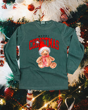 Adult long sleeve comfort colors tee in blue spruce with merry Christmas teddy graphic, shown on flat lay – Little Mama Shirt Shop