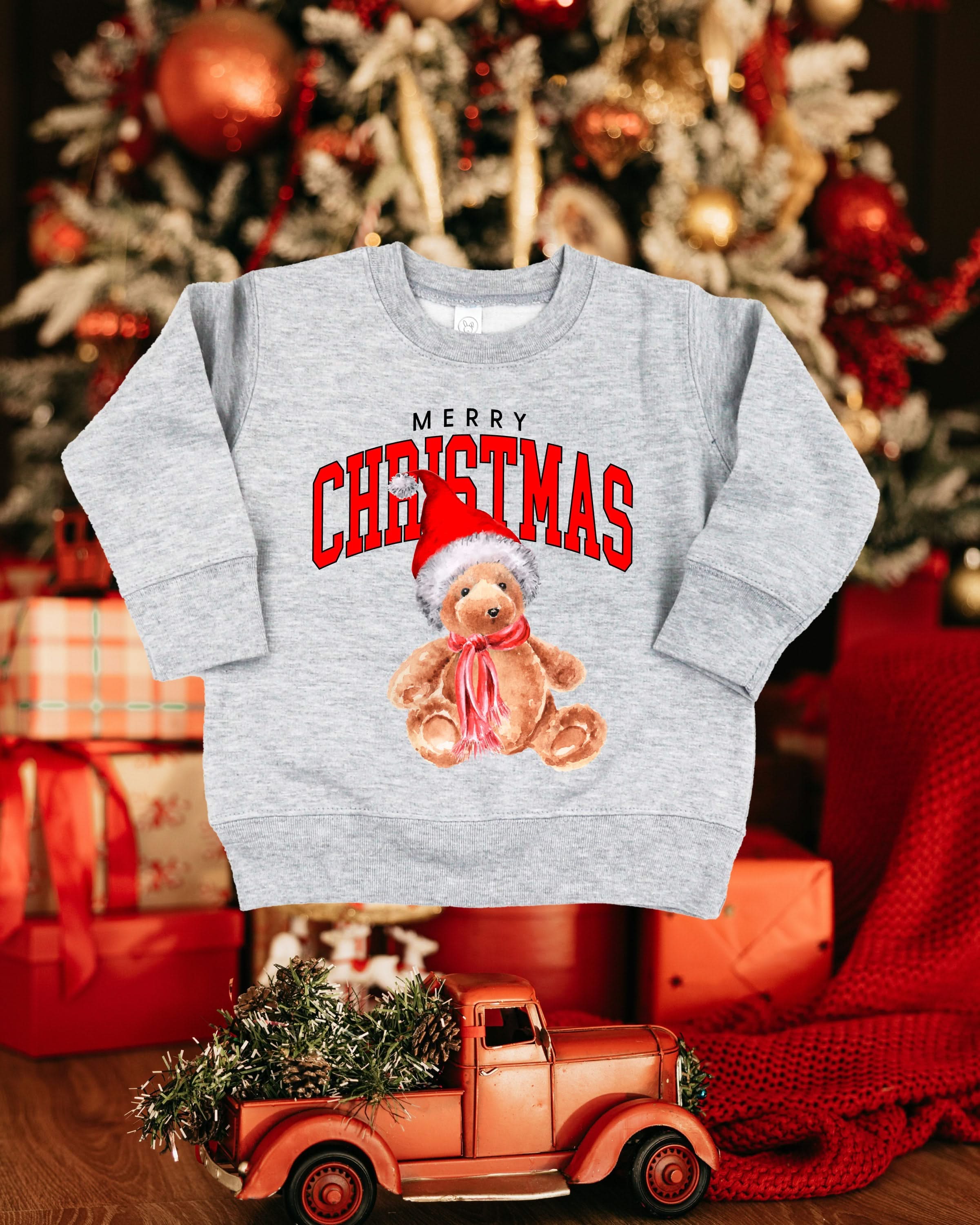Child gray basic fleece with merry Christmas teddy graphic, shown on flat lay – Little Mama Shirt Shop