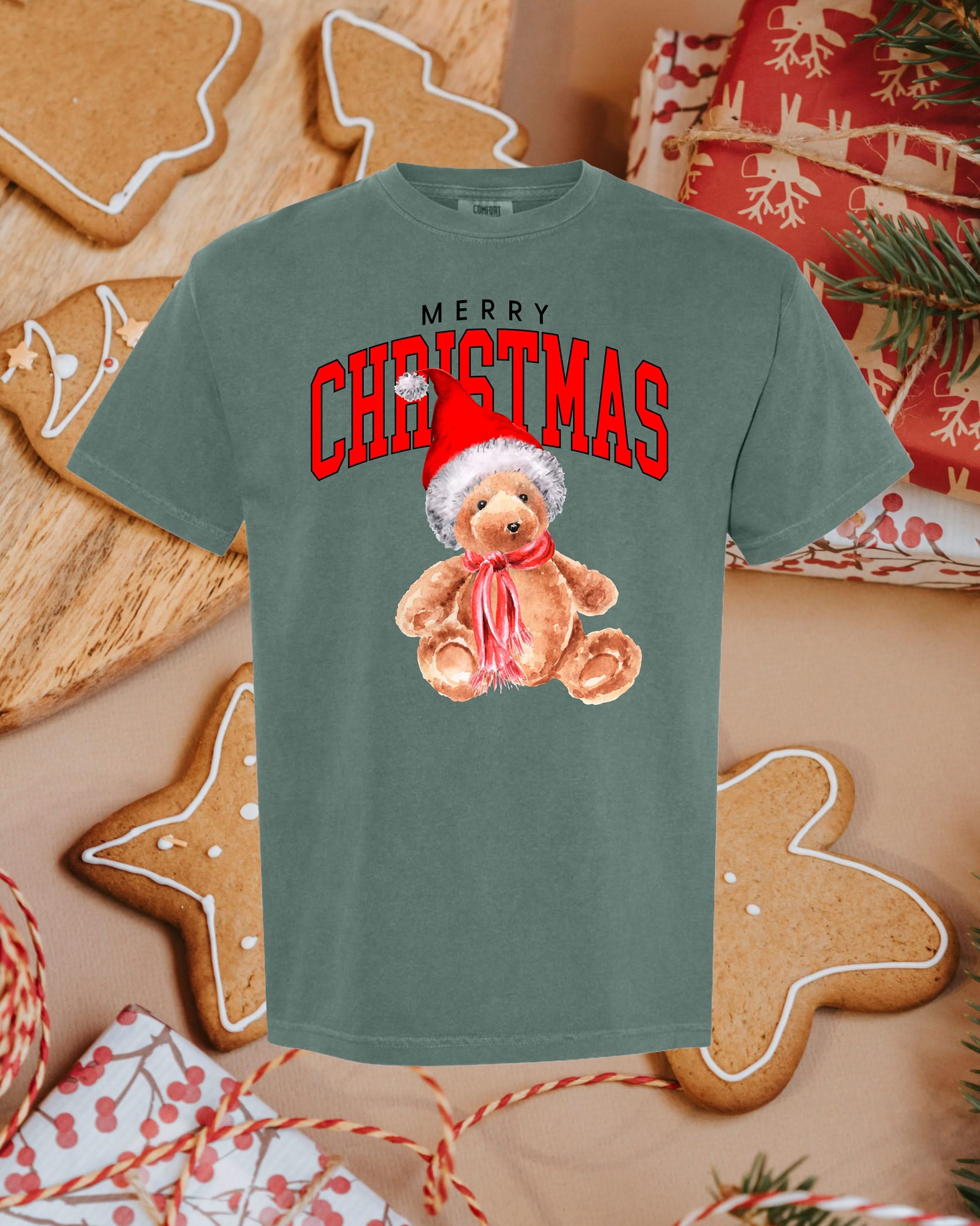 Adult comfort colors tee in blue spruce with merry Christmas teddy graphic, shown on flat lay – Little Mama Shirt Shop