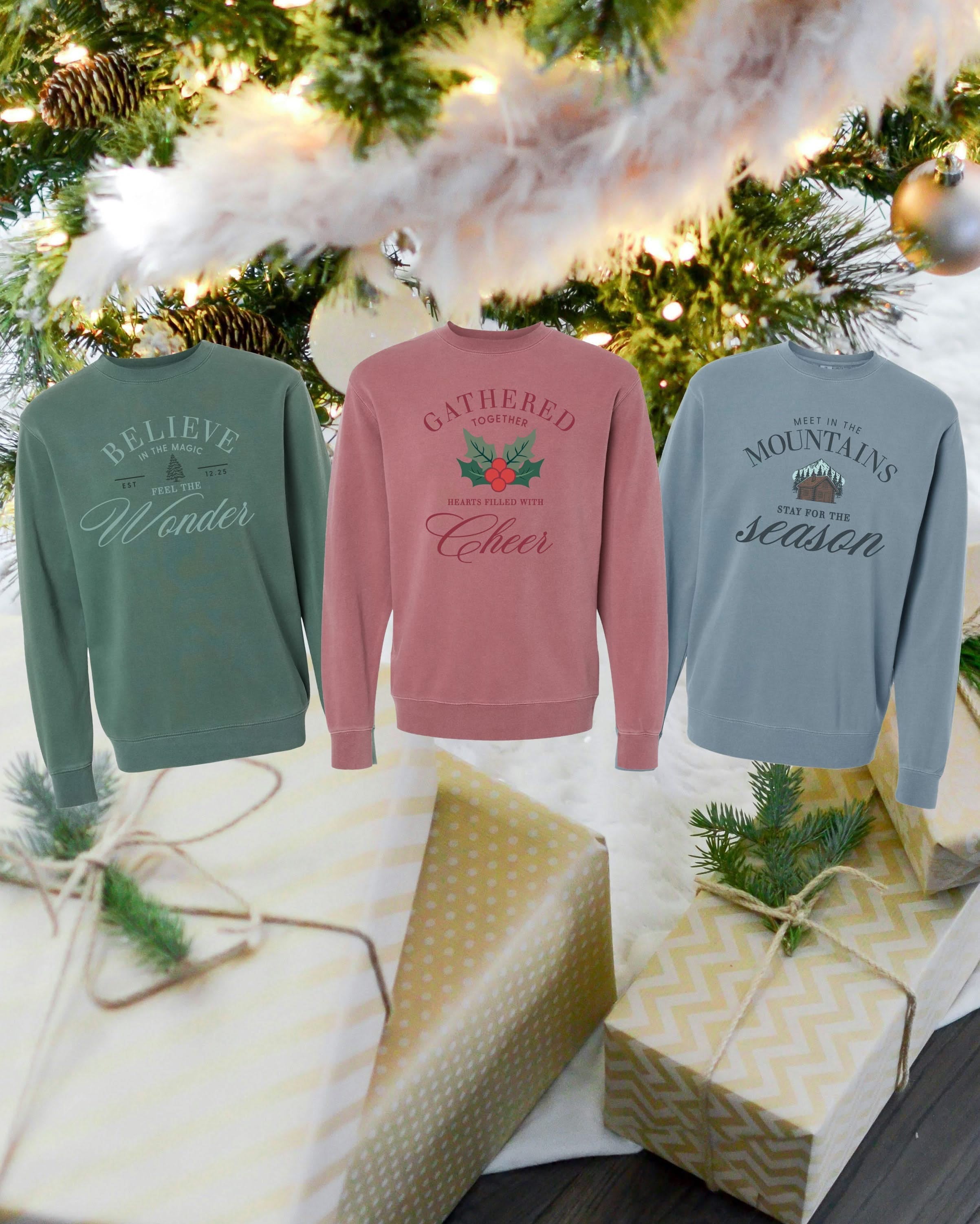 Adult sweater in alpine, maroon, and slate with The Winter Lodge collection designs on front, shown on flat lay – Little Mama Shirt Shop