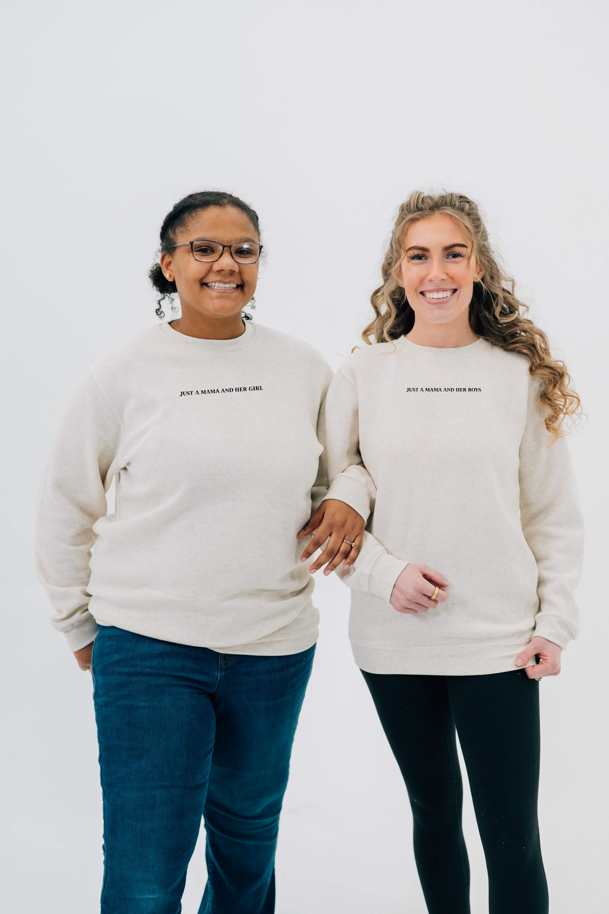 Adult sweaters in natural with "Just a Mama and Her ___" design on the front, seen on models - Little Mama Shirt Shop