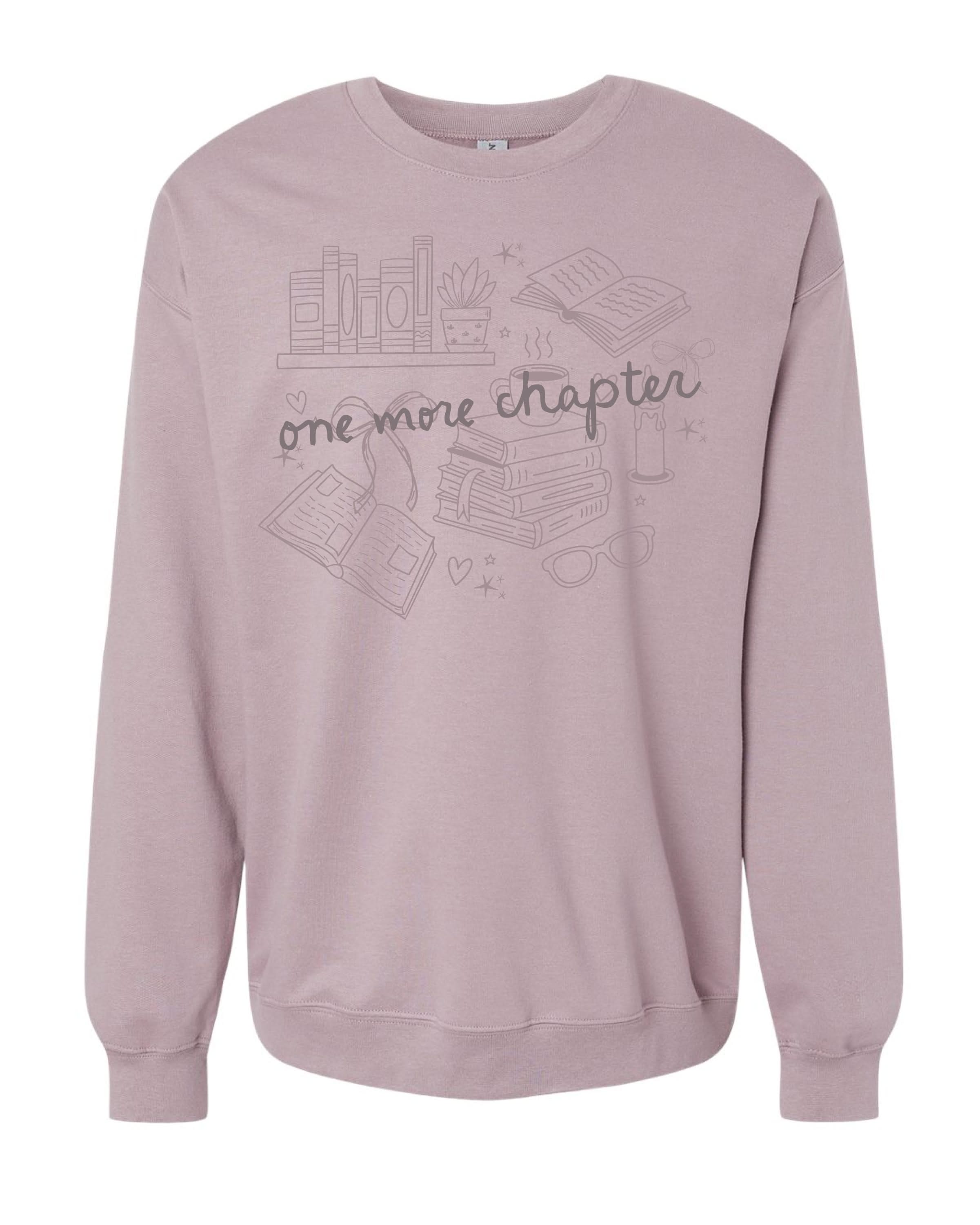 Unisex “One More Chapter” crewneck in paragon with cozy tone on tone book lover illustration, flat lay – Little Mama Shirt Shop