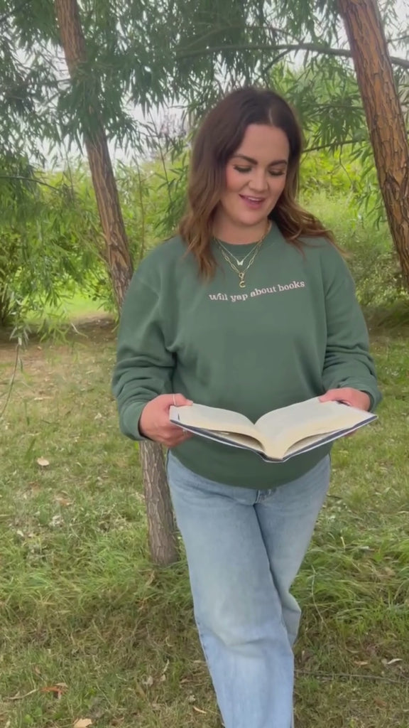 Video of embroidered “Will Yap About Books” pigment-dyed crewneck in pigment alpine with pink thread on model  – Little Mama Shirt Shop