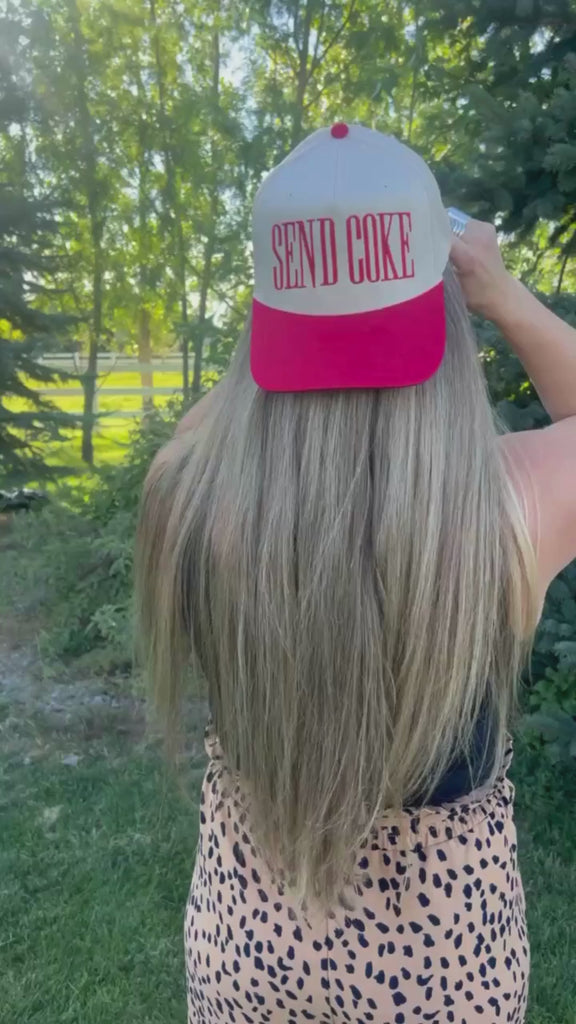 Video of red and cream trucker hat with bold red 'SEND COKE' text, seen on model - Little Mama Shirt Shop
