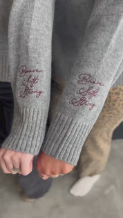 Video of gray sweater with "Brave, Soft, Strong" embroidered on the sleeve, seen on models - Little Mama Shirt Shop