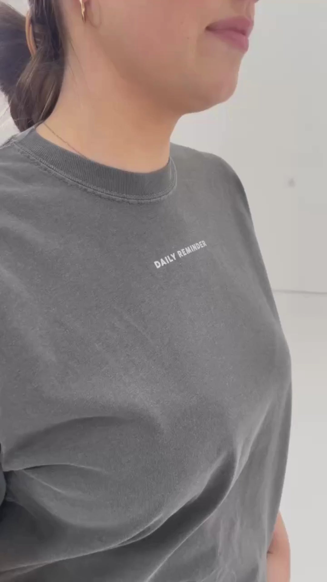 Video of pepper comfort colors tee with permission to be mountain graphic on back and daily reminder printed on front, seen on model - Little Mama Shirt Shop
