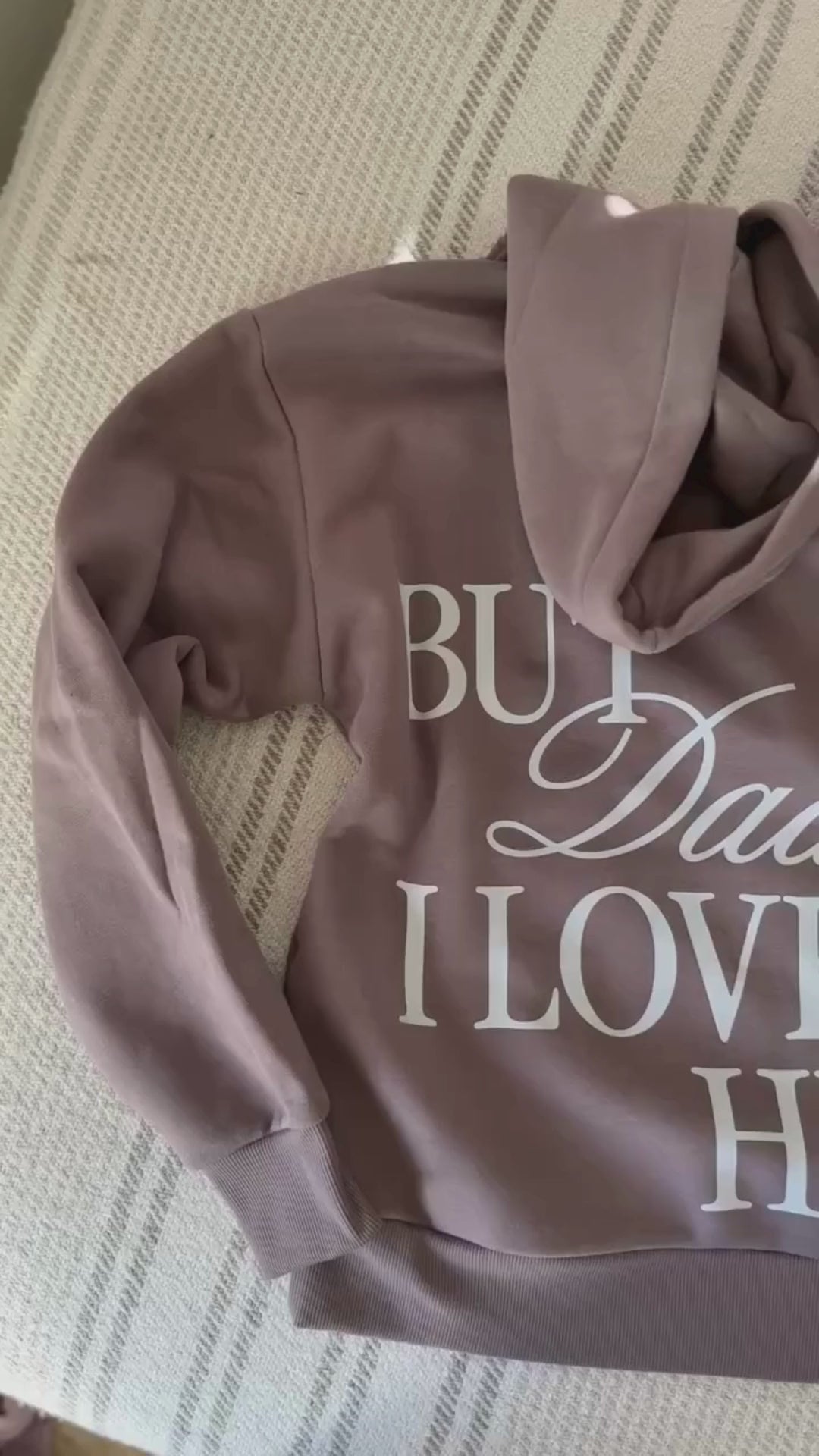 Video of Adult hoodie in brown with "But Daddy I Love Him" design on back and "loml" script on hood, shown on flat lay – Little Mama Shirt Shop