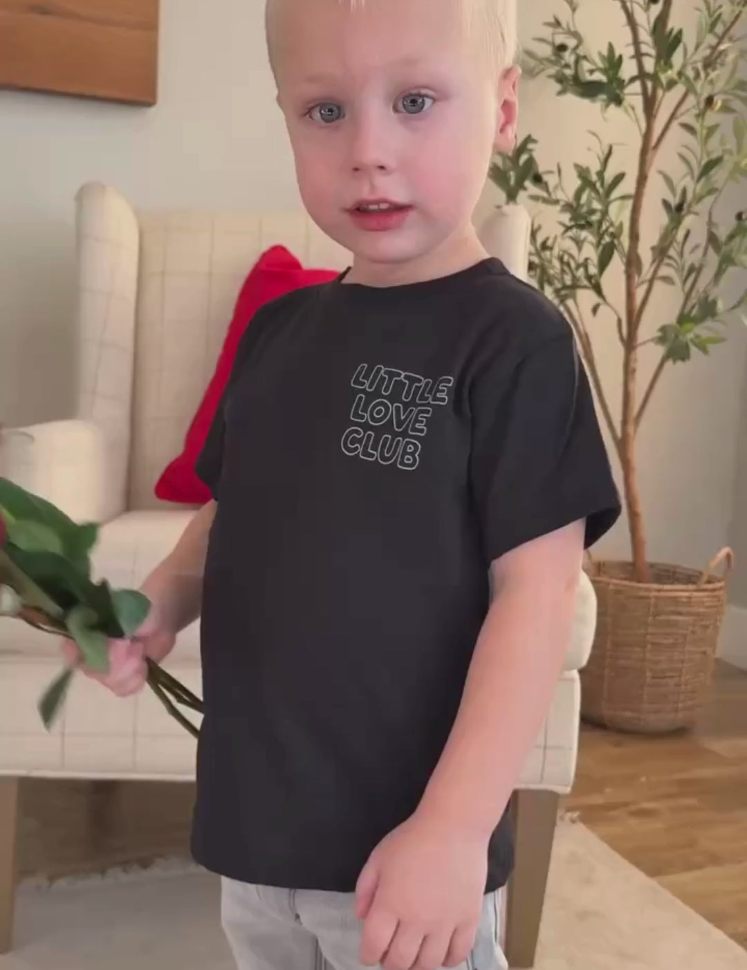 Video of Child tee in black with "Little Love Club" bubble letter text design on front left chest and back, shown on model – Little Mama Shirt Shop