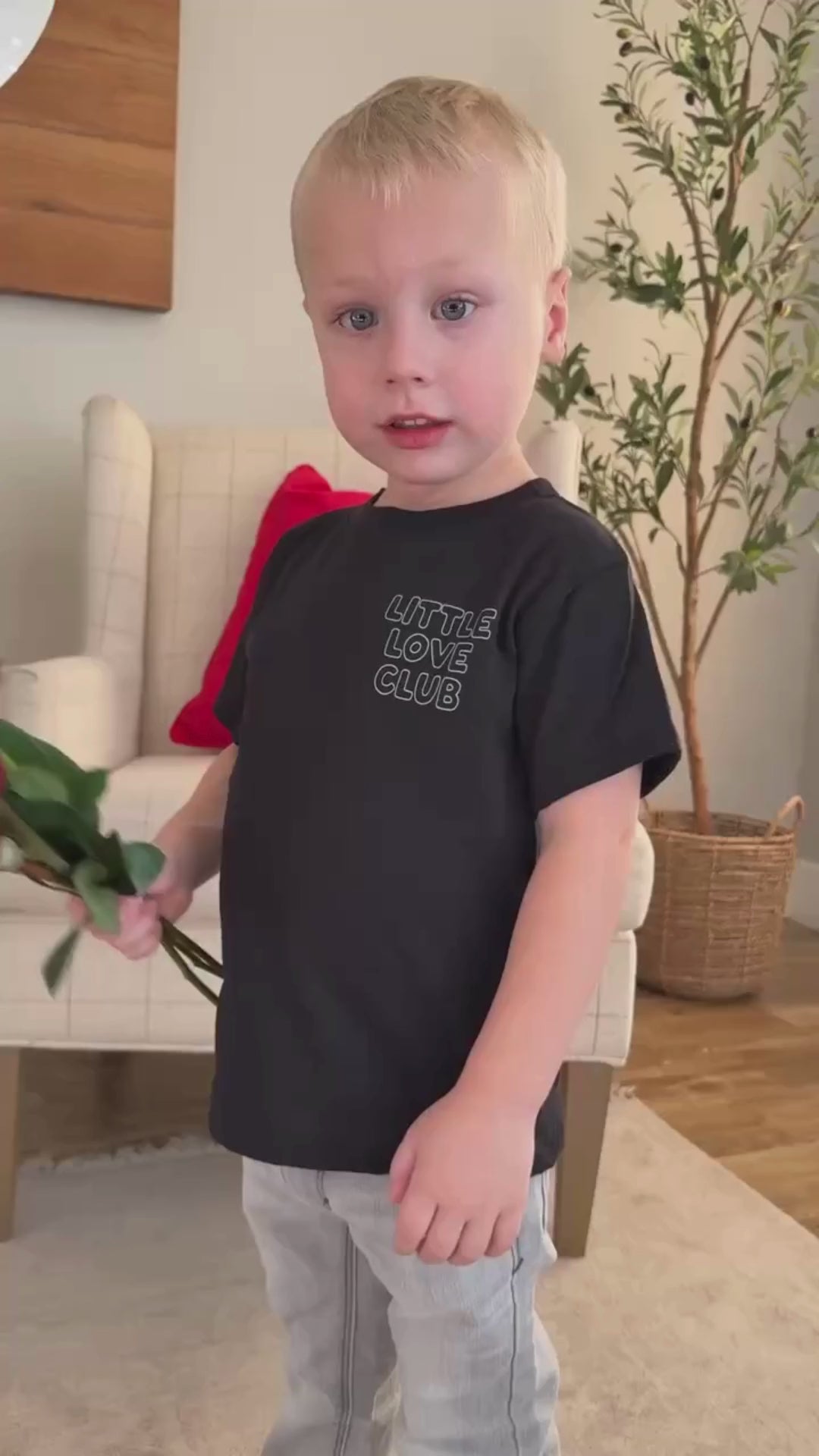 Video of Child tee in black with "Little Love Club" bubble letter text design on front left chest and back, shown on model – Little Mama Shirt Shop