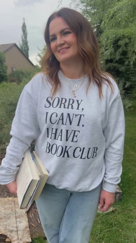 Video of unisex fleece sweatshirt in ash with “Sorry, I Can't. I Have Book Club.” design, on model – Little Mama Shirt Shop