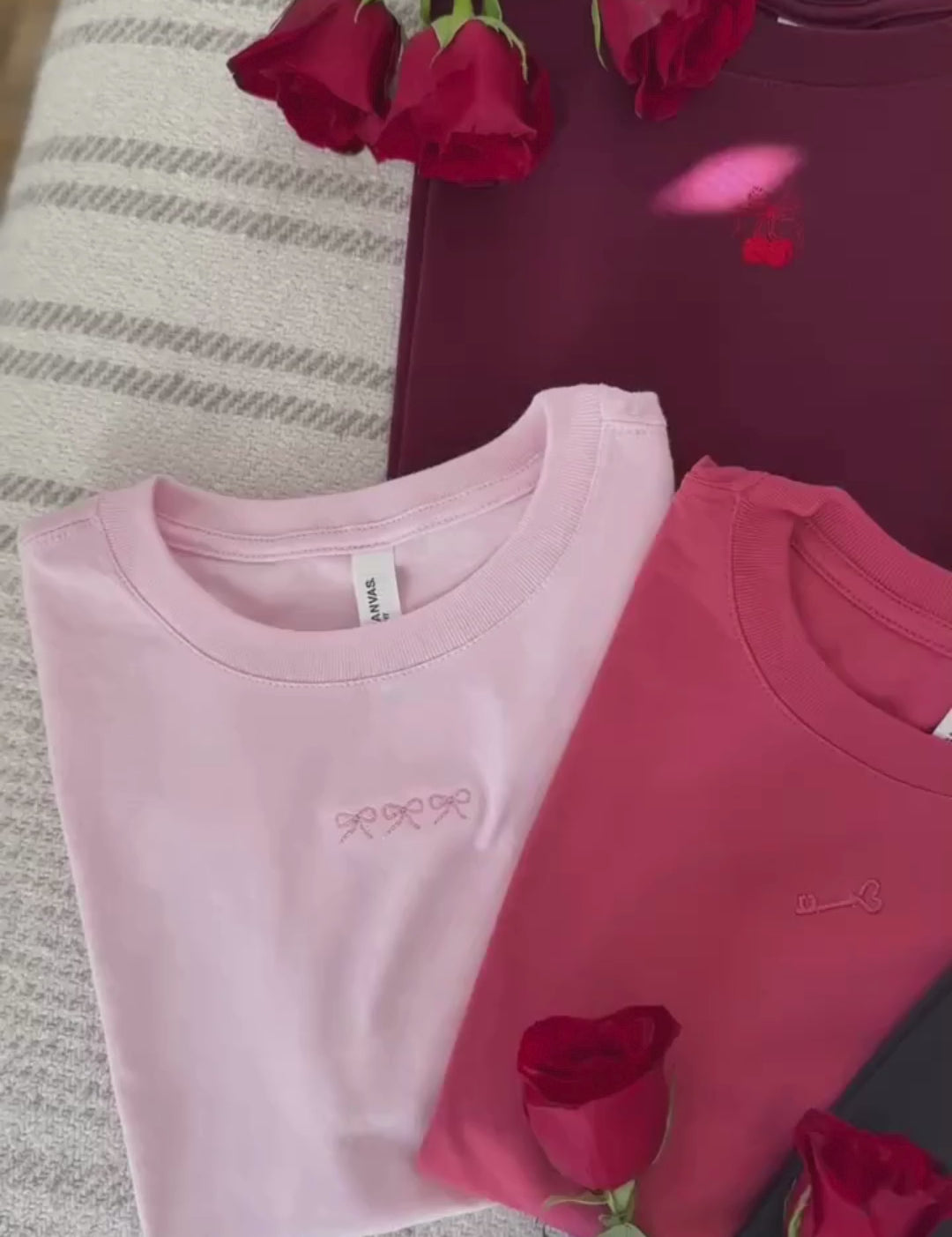 Panning Video of Adult tees in maroon, natural, soft pink, vintage red, and dark gray with mini symbol designs on front, shown on flat lay – Little Mama Shirt Shop