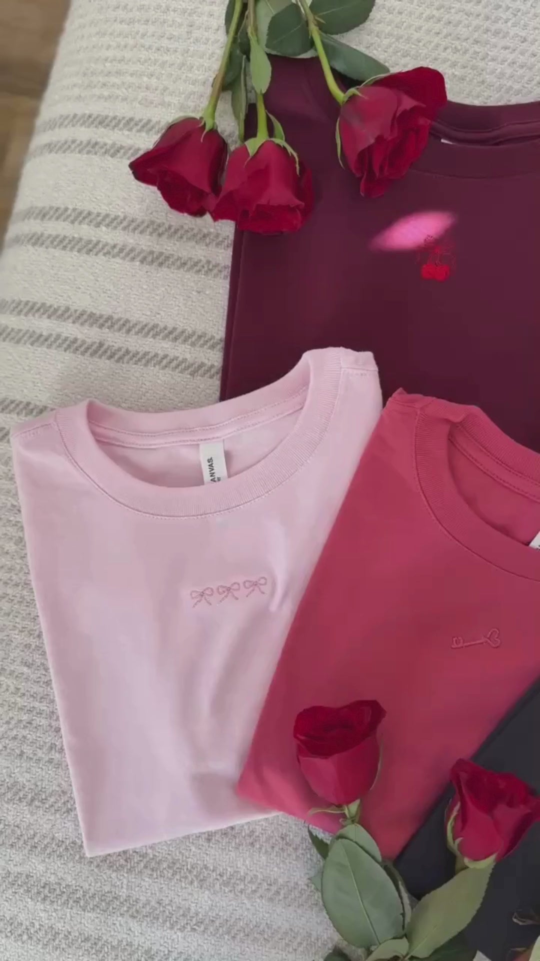 Panning Video of Adult tees in maroon, natural, soft pink, vintage red, and dark gray with mini symbol designs on front, shown on flat lay – Little Mama Shirt Shop