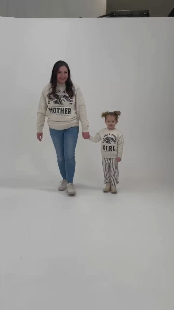 Video of adult and child sweaters in natural with "Not Your Average" design on front, shown on models – Little Mama Shirt Shop
