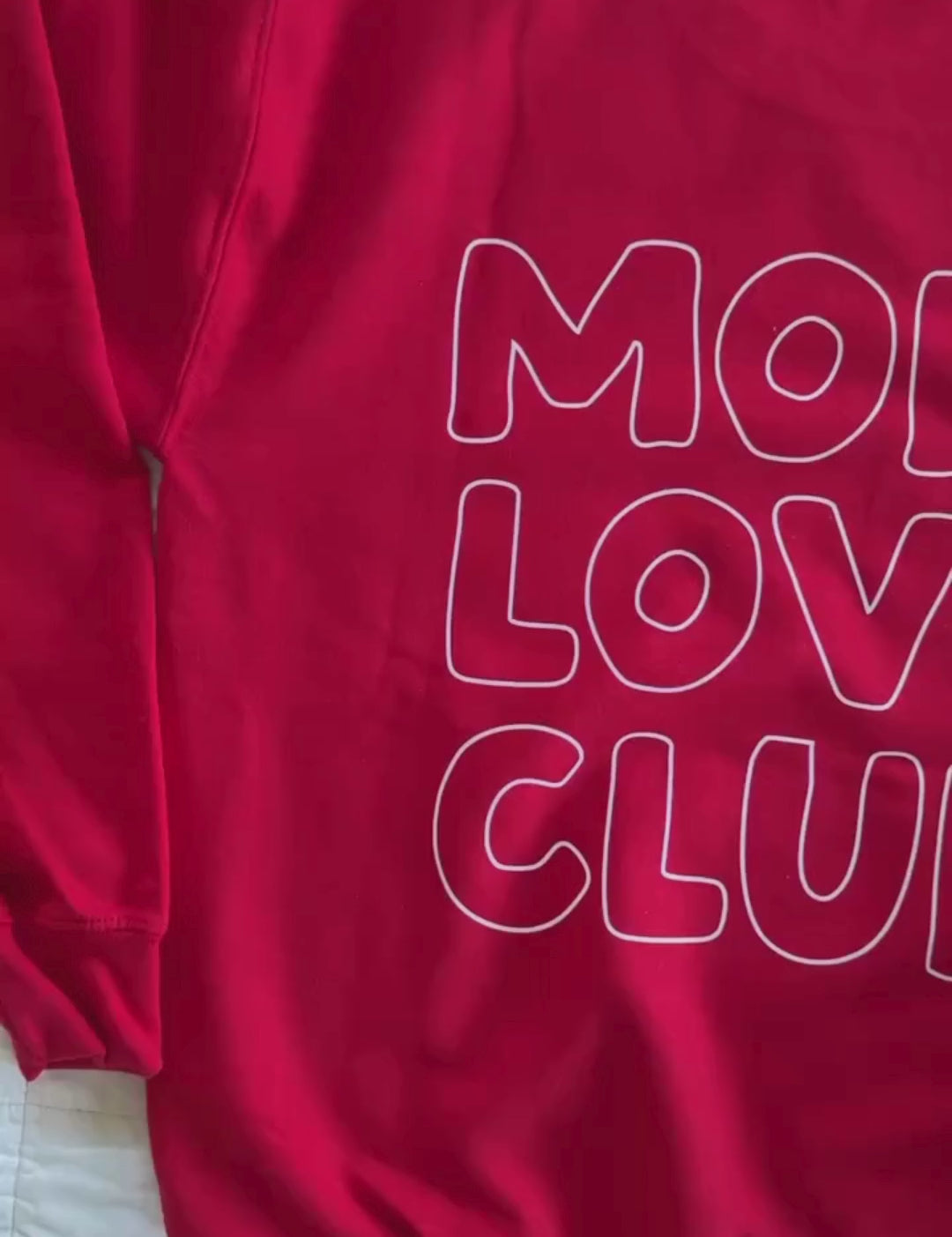 Video of adult sweater in red with "Mom Love Club" bubble letter text design on back and front left chest small, shown on flat lay – Little Mama Shirt Shop