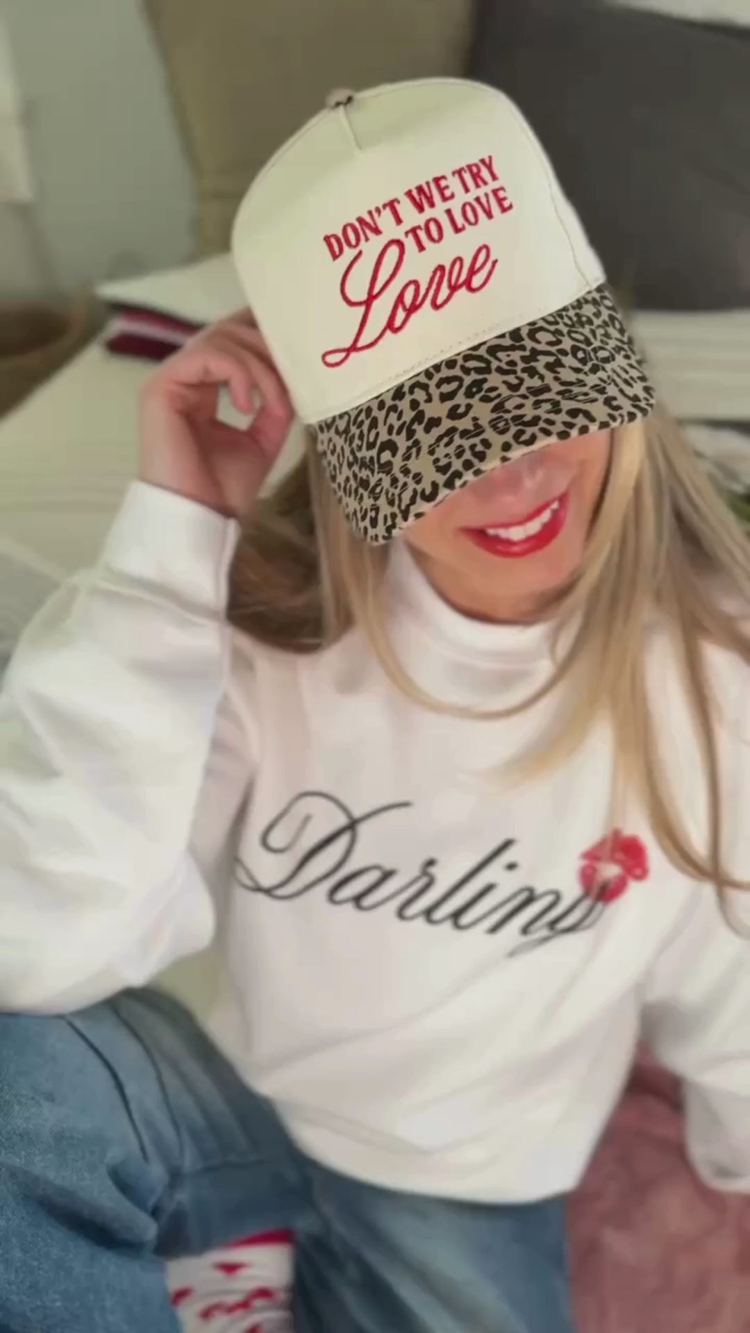 Video of adult cream and leopard hat with "Don't We Try To Love Love" design embroidered on front, shown on model – Little Mama Shirt Shop