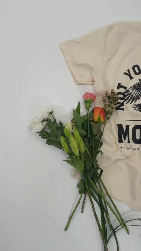 Video of adult and child tee in ivory and natural with "Not Your Average" design on front, shown on flat lay – Little Mama Shirt Shop