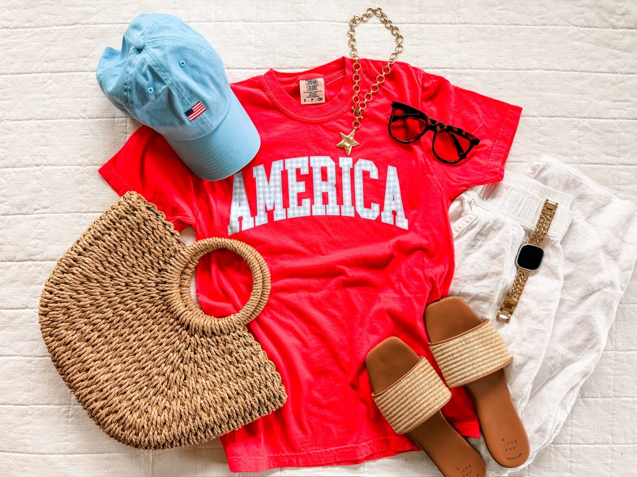 Red AMERICA shirt styled with woven accessories and sandals for an easy summer outfit idea