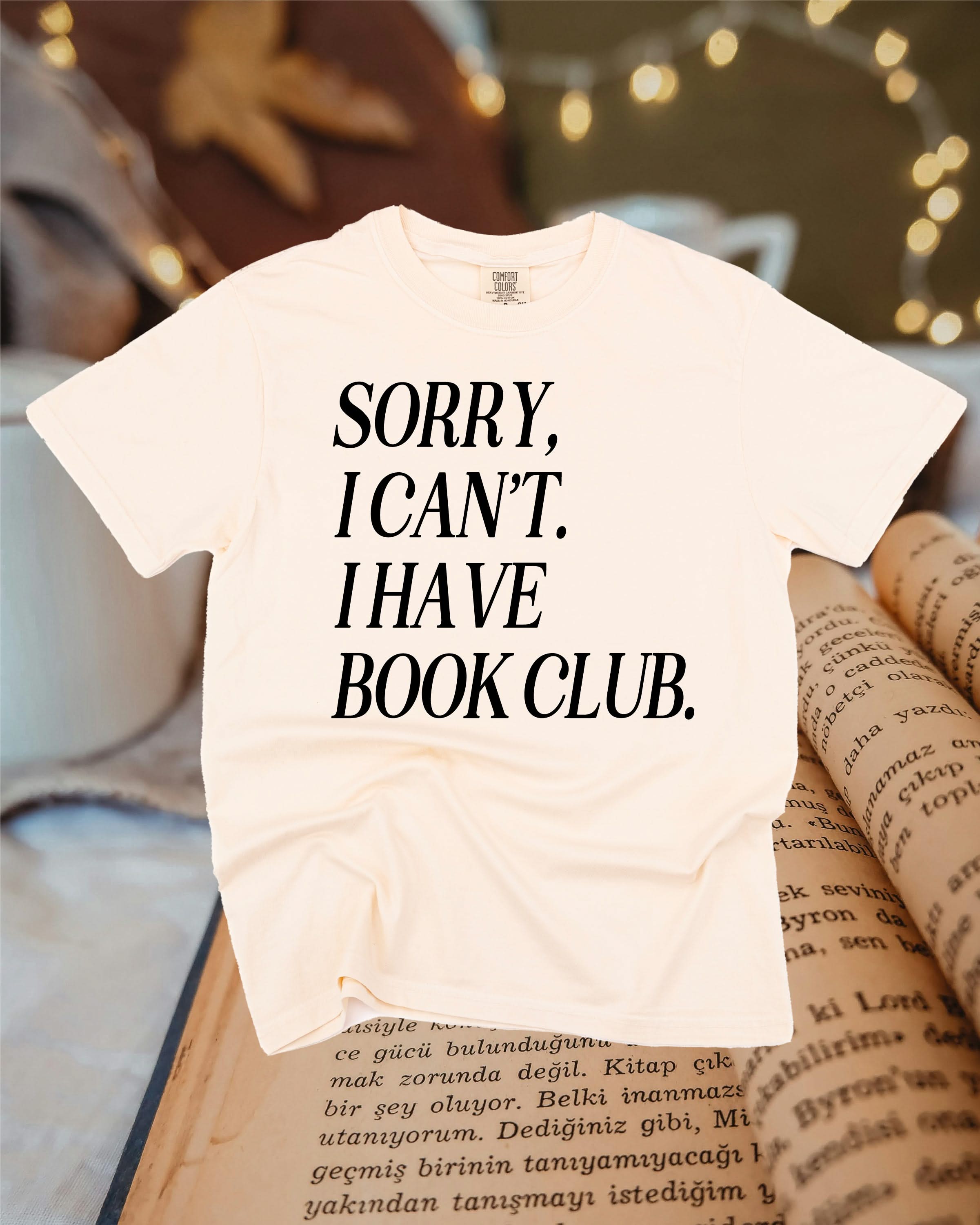 Unisex Comfort Colors “Sorry, I Can't. I Have Book Club." in ivory, flat lay – Little Mama Shirt Shop