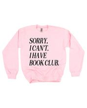 Unisex fleece sweatshirt in light pink with “Sorry, I Can't. I Have Book Club.” design, on flat lay – Little Mama Shirt Shop