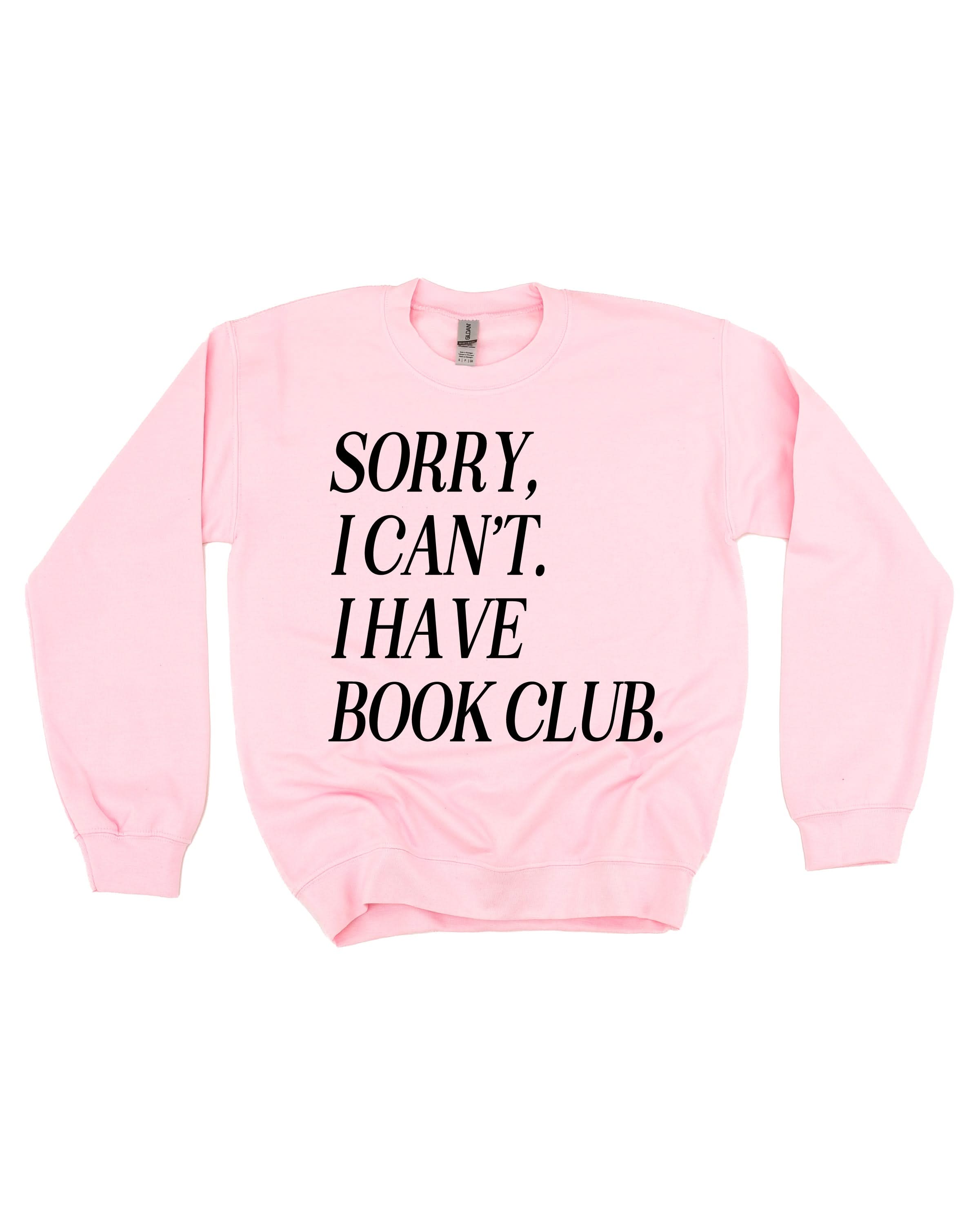 Unisex fleece sweatshirt in light pink with “Sorry, I Can't. I Have Book Club.” design, on flat lay – Little Mama Shirt Shop