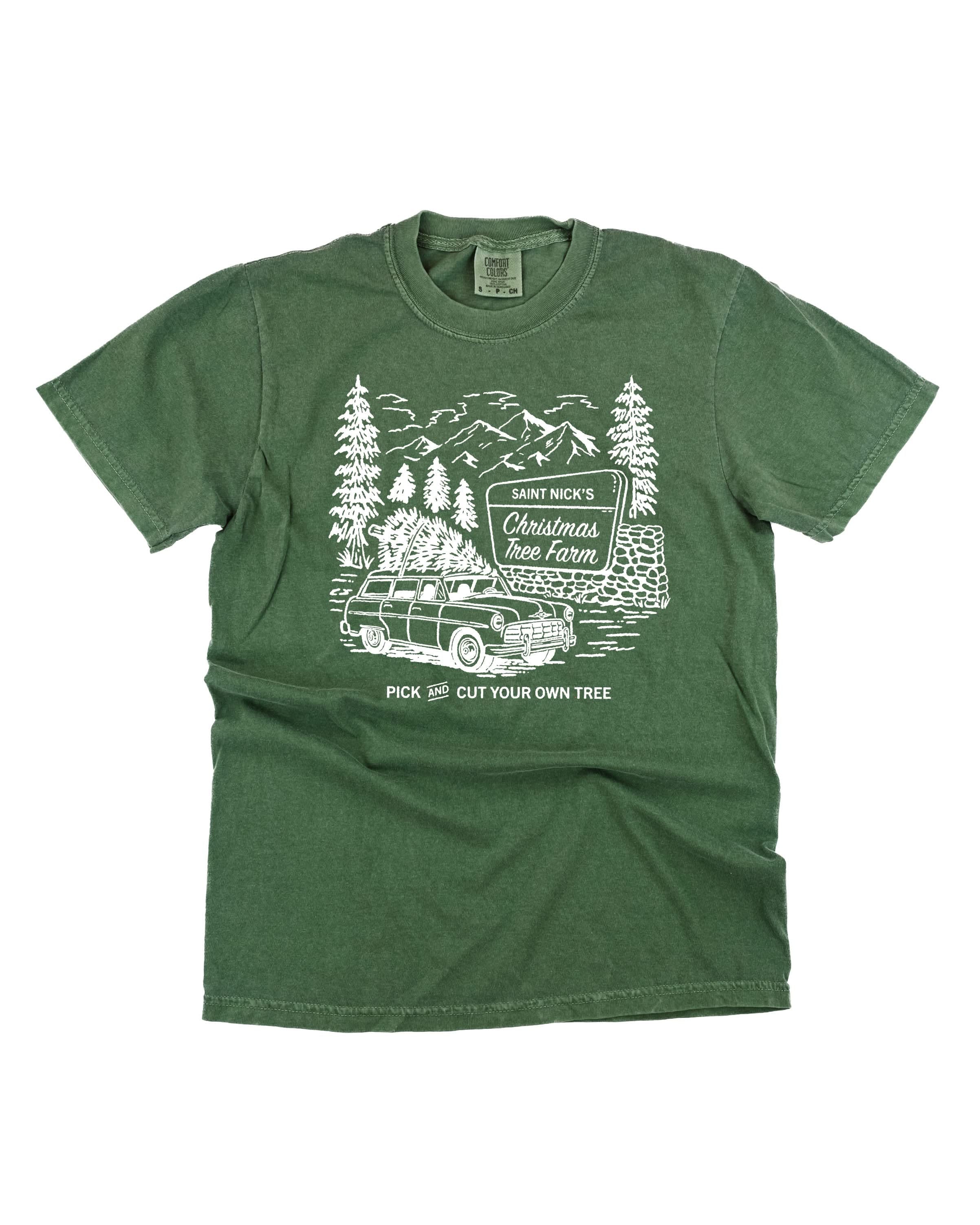 Comfort Colors Tee in hemp with St. Nick's Christmas Tree Farm graphic on the front, shown on flat lay – Little Mama Shirt Shop