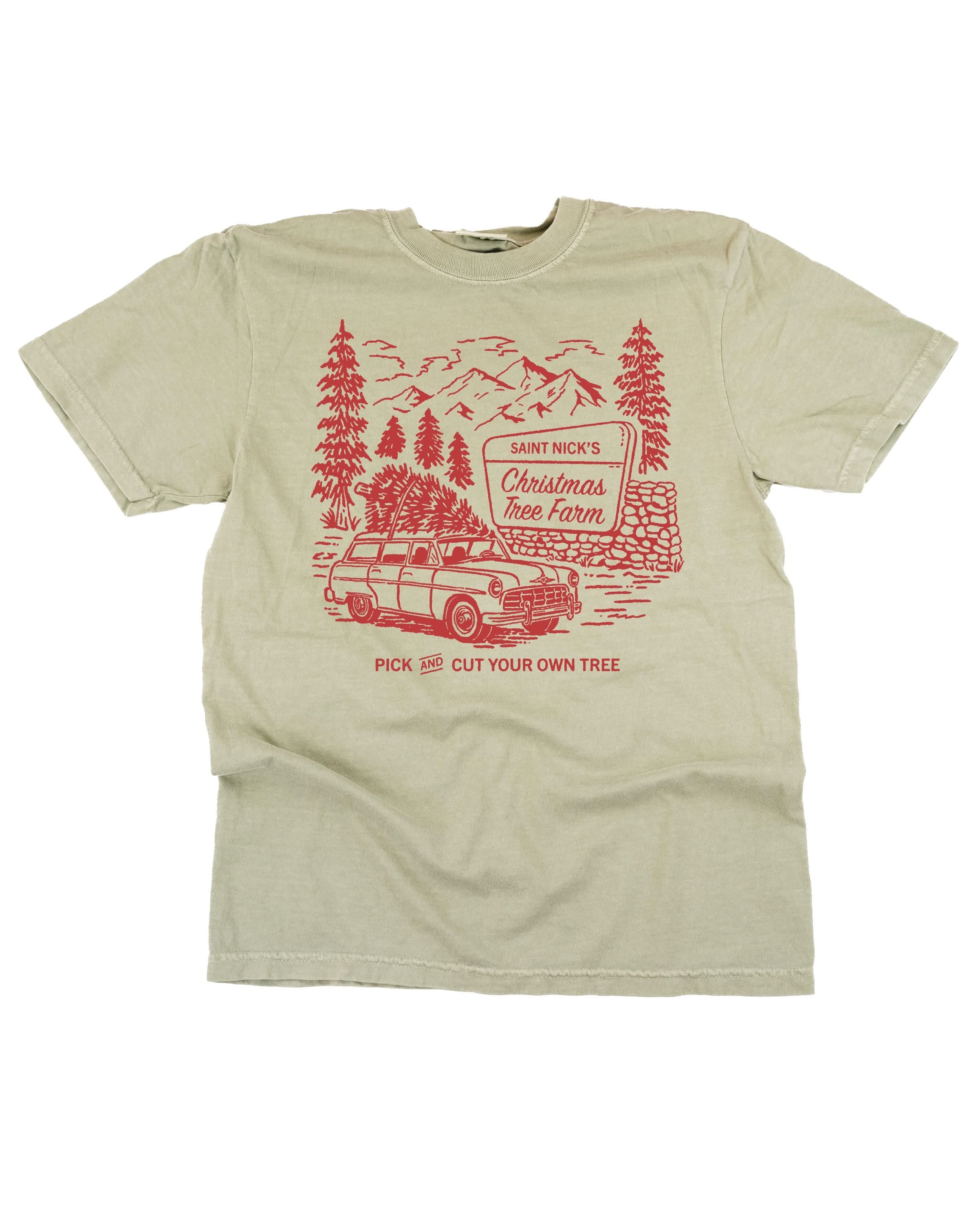 Comfort Colors Tee in sandstone with St. Nick's Christmas Tree Farm graphic on the front, shown on flat lay – Little Mama Shirt Shop