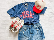 USA gingham shirt styled with denim shorts and accessories, red white and blue outfit idea, trendy patriotic clothing