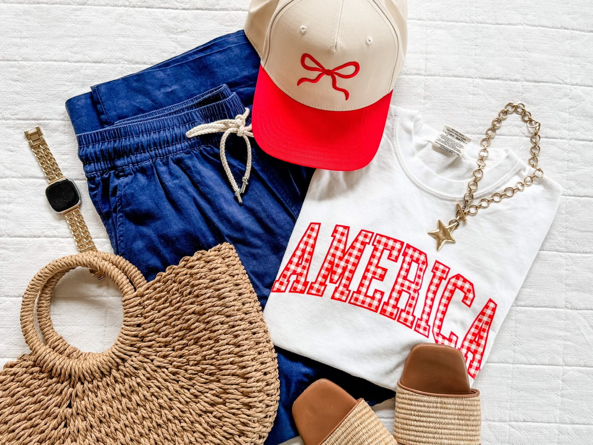White AMERICA gingham shirt styled with denim shorts and summer accessories for a relaxed holiday outfit