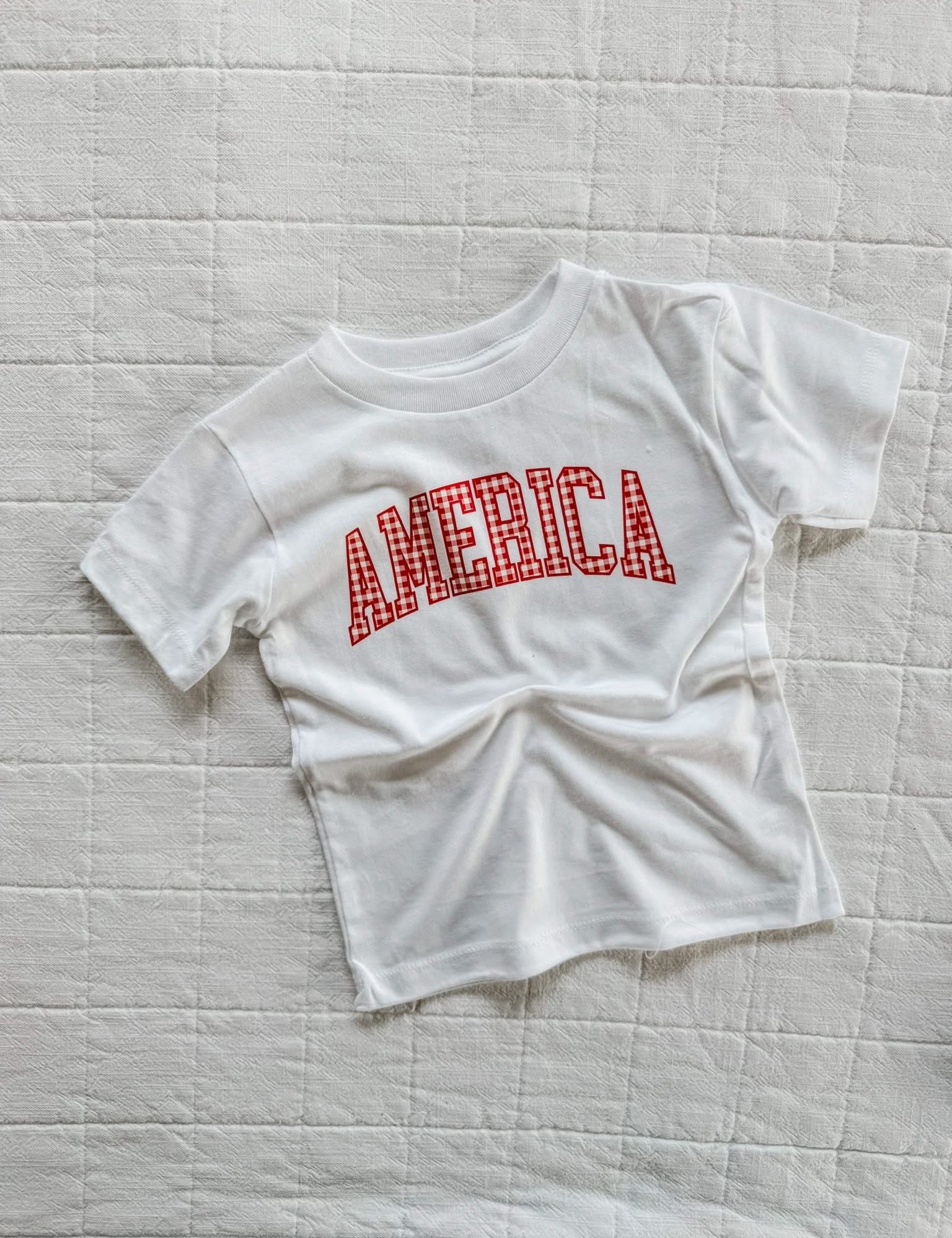 White AMERICA shirt for kids with gingham design, a light and classic option for warm weather