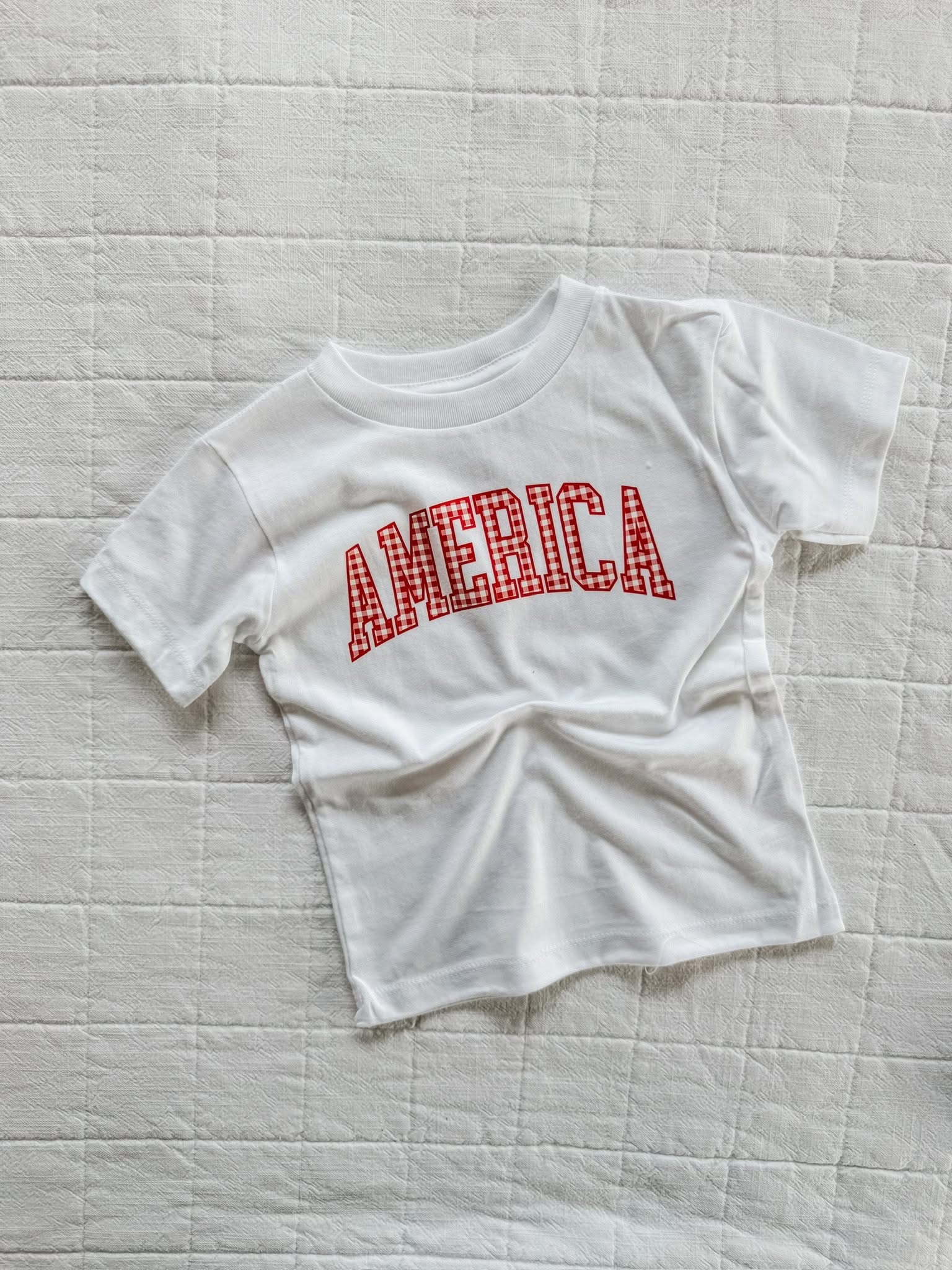 White AMERICA shirt for kids with gingham design, a light and classic option for warm weather
